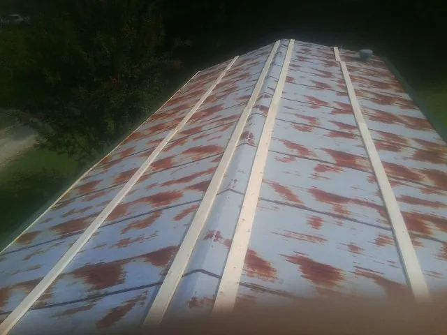 Rusted metal roof panels with new wood purlins before replacement — Storm Damage Roof Repair in Newberg by Roofing Brothers