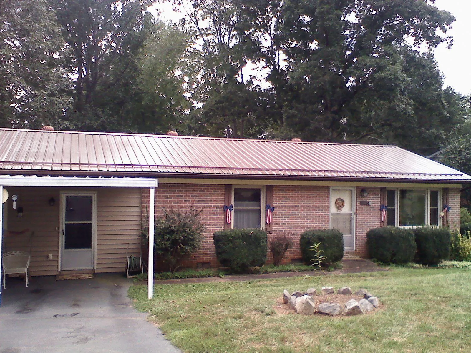 Bronze metal roof and carport on a brick ranch home — Roof Repair work by our crew in Newberg